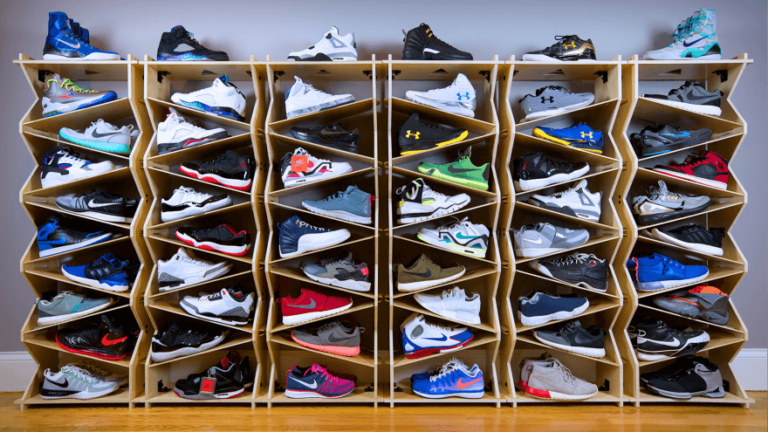 Overhead shot of a collector's shelving unit with neatly organized boxes of sneakers, labels facing out, clean room setup